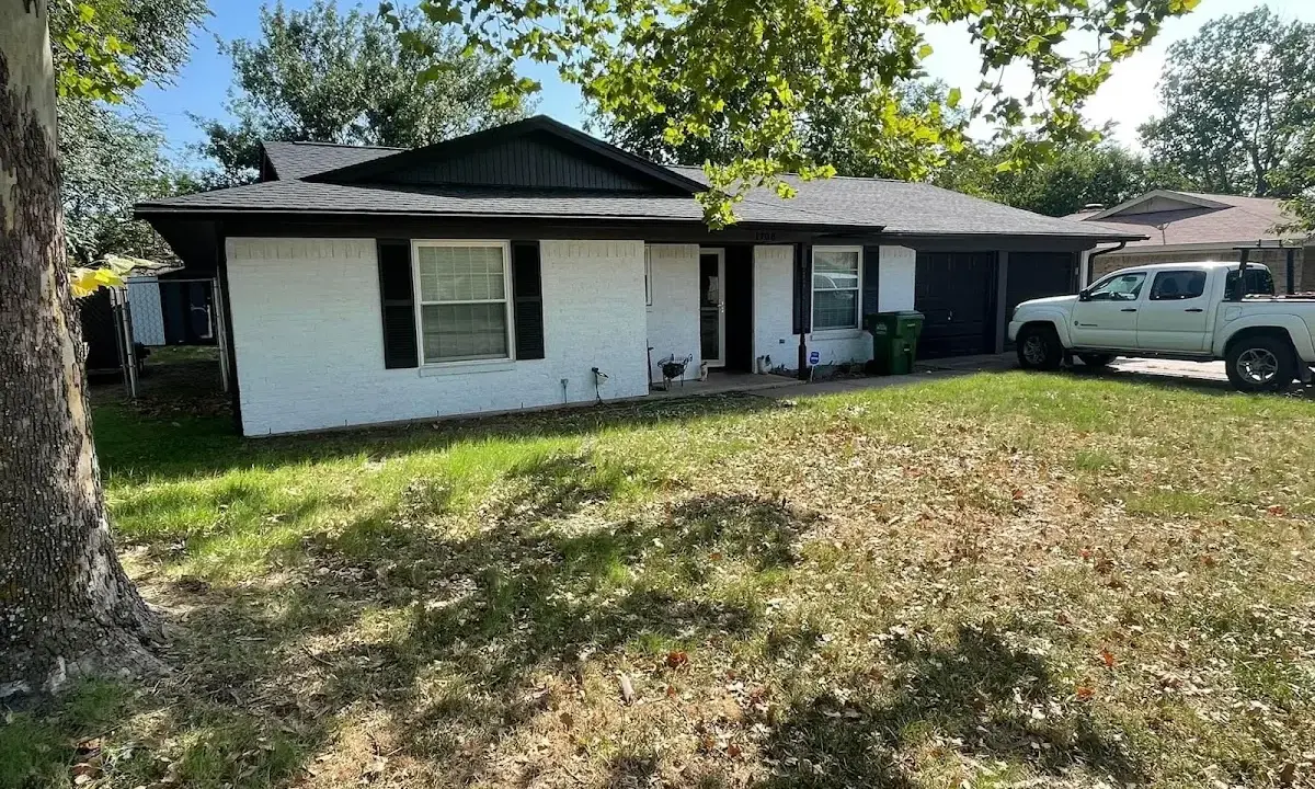 Professional roofing crew working on a residential roof in Tarrant